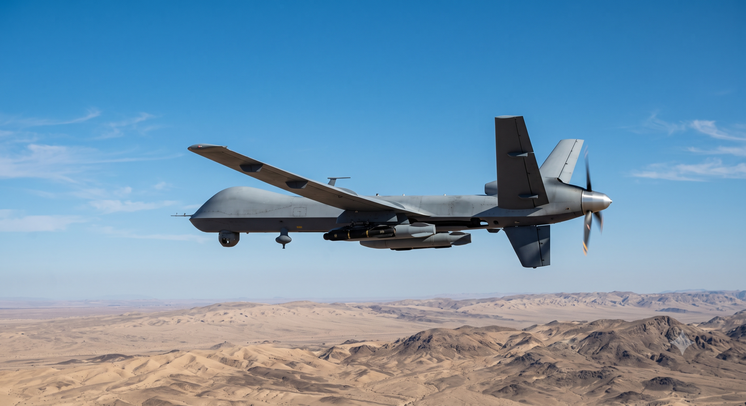 Military MQ-9 Reaper drone flying against a clear sky